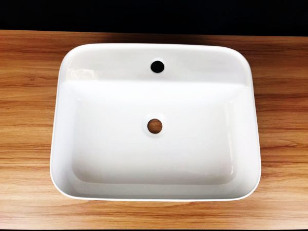 Camber rectangular above counter wash basin with taphole